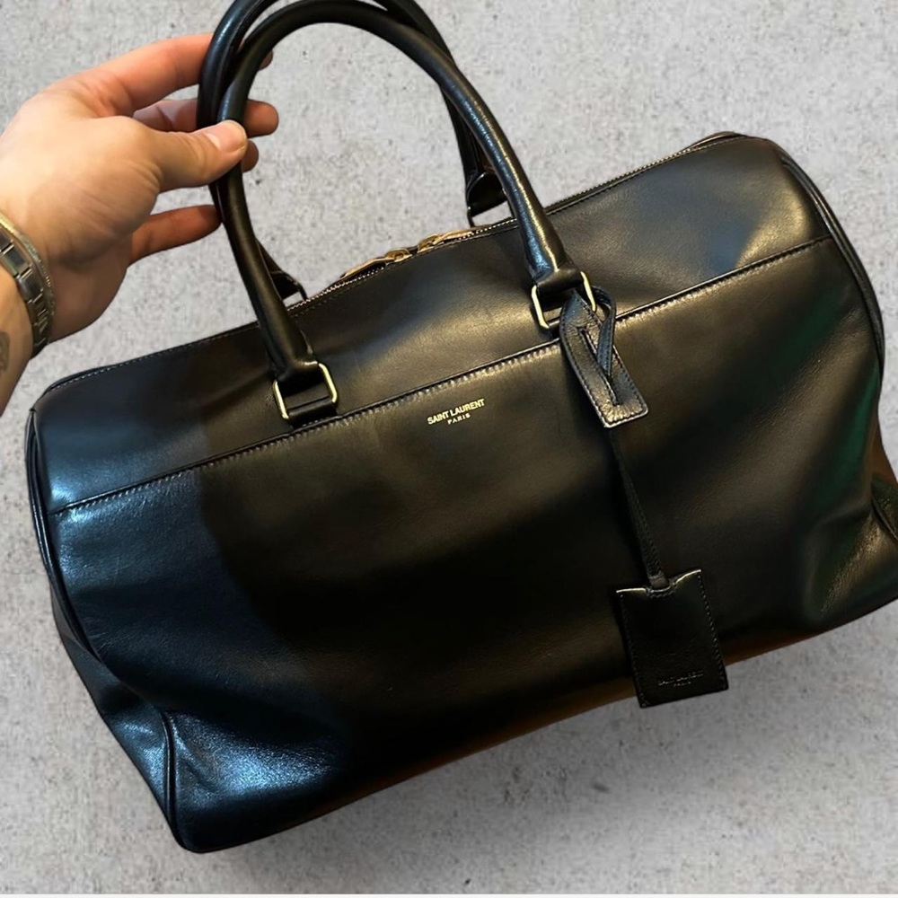 SAINT LAURENT Black leather duffle bag and crossbody